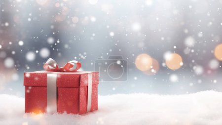 Téléchargez les photos : Un coffret cadeau rouge avec un ruban argenté, niché dans la neige avec un fond de lumière bokeh - en image libre de droit