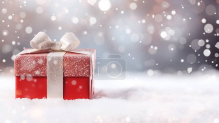 Photo for Sparkling red gift box with a silky ribbon in a snowy setting, soft bokeh lights in the distance - Royalty Free Image