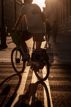 Photo for Paris, France - July 16, 2022: Paris Street Scene of unrecognizable biker at sunset - Royalty Free Image