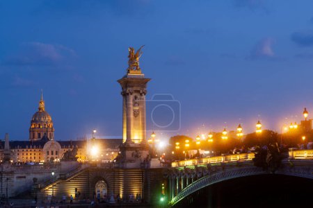 Photo for Pont Alexandre III Bridge and illuminated lamp posts at sunset with view of the Invalides. 7th Arrondissement, Paris, France - Royalty Free Image