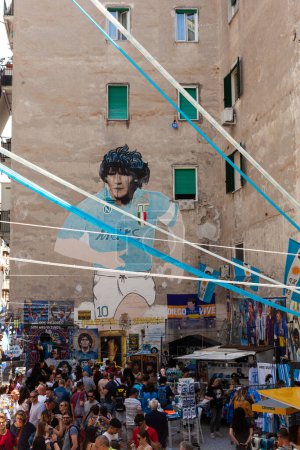 Photo for Naples, Italy - June 16, 2023: Murals of Diego Armando Maradona with the Napoli shirt located in the Quartieri Spagnoli, Spanish quarters, in the historic center of the city. There are so many people and tourist visiting. - Royalty Free Image
