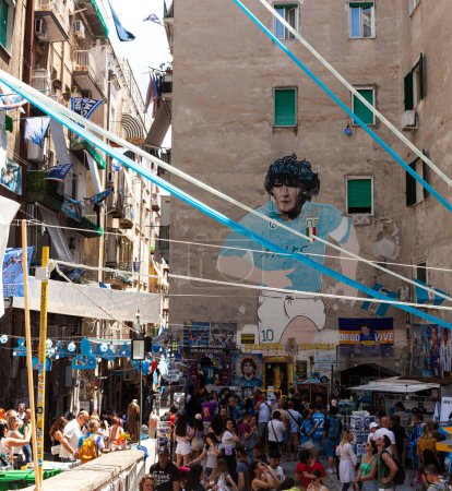 Photo for Naples, Italy - June 16, 2023: Murals of Diego Armando Maradona with the Napoli shirt located in the Quartieri Spagnoli, Spanish quarters, in the historic center of the city. There are so many people and tourist visiting. - Royalty Free Image