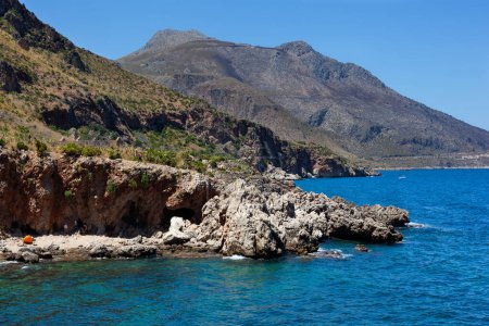 Bathers and hikers in the Cala della Disa, Disa inlet, Natural Reserve of the Zingaro in the province of Trapani