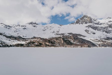 Saint Moritz, Switzerland - March 2024: Breathtaking mountains covered by snow around the Sils lake and Maloja village