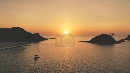 Sunset seascape of ocean bay at tropic islands aerial. Nobody nature landscape with palm trees at sand beach. Summer paradise resort at sea gulf. Sandy shore of El Nido Islet, Philippines, Asia