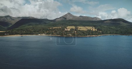 Scotlands ocean bay scenery aerial panoramic view from Goat fell, Brodick Harbour, Arran Island. Majestic Scottish landscape of mountain: forests, meadows and medieval castle shot