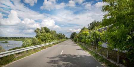 Photo for Bright summer Ukrainian road, beautiful, peaceful sunny day, beautiful clouds and blue sky, river and greenery, freedom! - Royalty Free Image