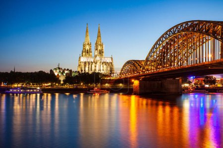 Cologne Cathedral and Hohenzollern Bridge through Rhine river in Cologne, Germany