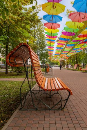 Photo for Radauti, Romania: Bench in the city center with colorful umbrellas. Romania - Royalty Free Image