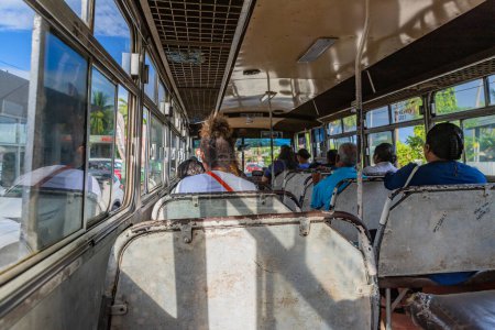 Photo for Nadi, Fiji: Indigenous Fijian people travel by bus. In Fiji every town and village has a bus stop since this is still the most common form of transportation in the islands. - Royalty Free Image