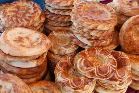 Photo for Tandoor naan or tandoor bread sold at the market in Kyrgyzstan. Traditional asian food - Royalty Free Image