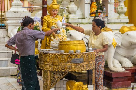 Photo for Yangon, Myanmar: Worshippers visit Shwedagon Pagoda. Shwedagon Pagoda is the most sacred Buddhist pagoda in Myanmar. - Royalty Free Image