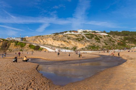 Photo for Sintra, Portugal: People at the beach of Magoito in a winter day, Sintra, Portugal - Royalty Free Image