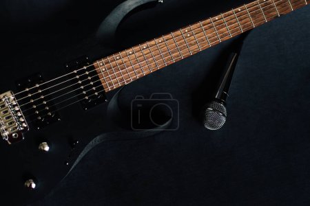 close up black electric guitar on black background