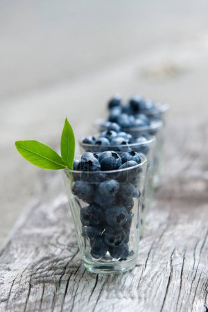 Ripe blueberries on a wooden background. Fruit appetizing background.