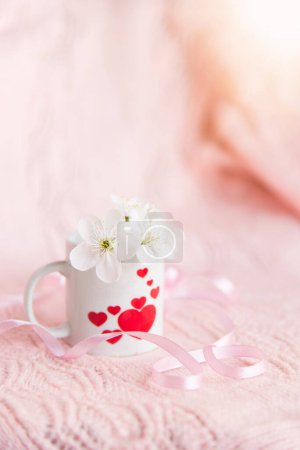 Foto de Valentine's day concept. white cup for coffee with hearts on a pale pink background - Imagen libre de derechos