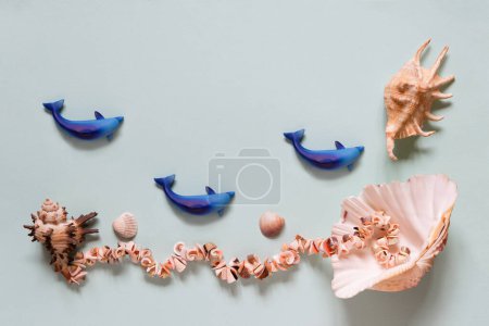 Photo for Seashells. Summertime concept. Flat lay composition with beautiful sea shells on blue background, top view, mockup, copy space for text. - Royalty Free Image