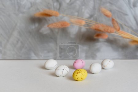 Foto de Huevos de Pascua y flores secas. Fondo gris vacío con espacio de copia - Imagen libre de derechos