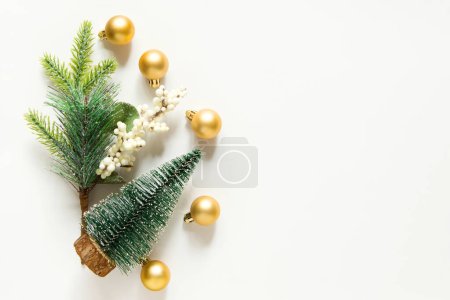 Téléchargez les photos : Décoration festive de Noël jouets en or. Espace vide pour l'espace de copie. plan plat, vue sur le dessus. nouvel an fond avec arbre de Noël sur un fond blanc clair. - en image libre de droit