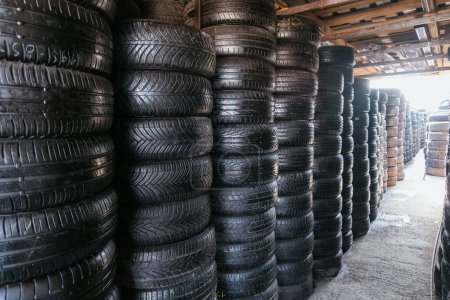 Photo for Stack of tires for sale in warehouse. - Royalty Free Image