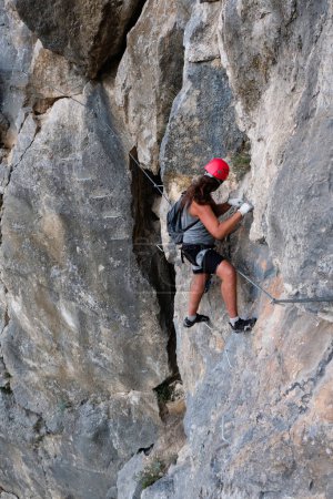 Photo for Man in helmet climbing on a rock. Rock climber training - Royalty Free Image
