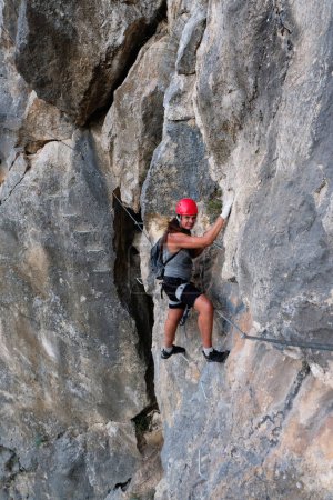 Photo for Man in helmet climbing on a rock. Rock climber training - Royalty Free Image