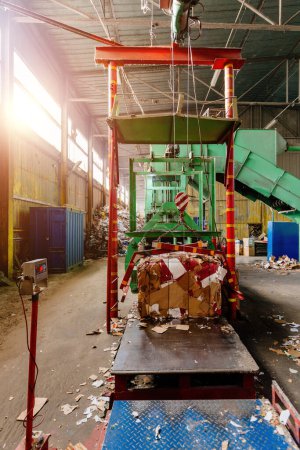 Photo for Pressing and baling of wastepaper in recycling factory. - Royalty Free Image