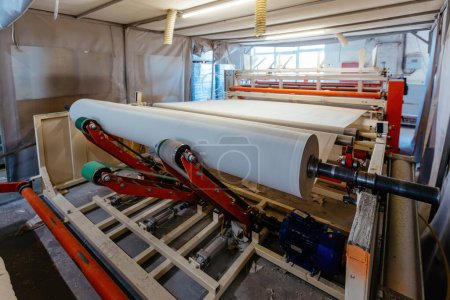 Photo for Toilet paper production line. Winder with roll of paper for further cutting and packing. - Royalty Free Image
