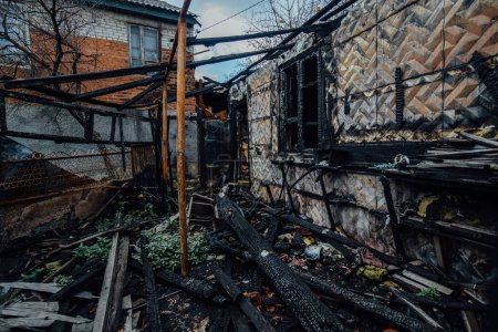Photo for Burnt ruined house. Consequence of fire or war. - Royalty Free Image