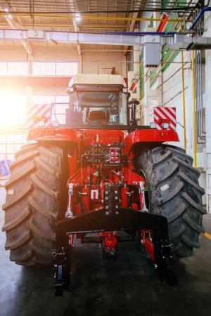 Photo for Rear view of modern agricultural tractor in hangar. Hydraulic hitch. Hydraulic lifting frame. Rear mechanism for attaching trailed equipment - Royalty Free Image