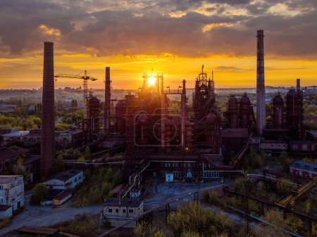 Blast furnace equipment of the metallurgical plant at the sunset, aerial view.