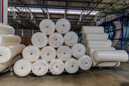 Photo for Packs of rolled foam rubber in warehouse. - Royalty Free Image