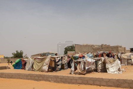 Photo for Refugee IDP camp (IDP - Internal displaced person) taking refuge from armed conflict.  People staying in very poor living conditions in huts made of clothing and plastic sheeting, lack of water, hygiene, shelter and food - Royalty Free Image