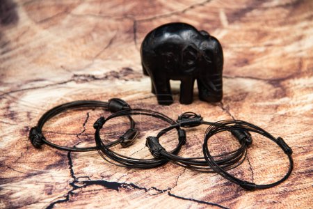 African bracelets made from elephant hair from tail, with small elephant figurine in background