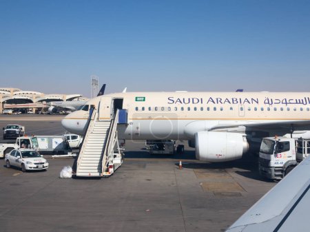 Photo for Riyadh - March 01:  Planes preparing for take off at Riyadh King Khalid Airport on March 01, 2016 in Riyadh, Saudi Arabia. Riyadh airport is home port for Saudi Arabian Airlines. - Royalty Free Image