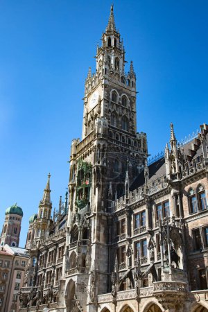 Photo for Main square of the Munich, Germany - Marienplatz (Marian square). The old and new city halls, Marian column, church Frauenkirche and Fish's fountain together are forming unique architectural style of the square - Royalty Free Image