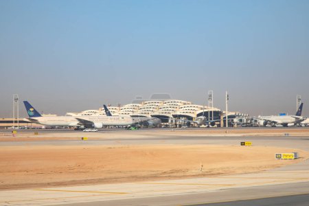 Photo for Riyadh - March 05:  Planes preparing for take off at Riyadh King Khalid Airport on March 05, 2023 in Riyadh, Saudi Arabia. Riyadh airport is home port for Saudi Arabian Airlines. - Royalty Free Image