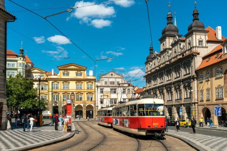 PRAGUE, CZECH REPUBLIC - SEPTEMBER 03, 2019: People and typical tram on the street among historic buildings in old city of Prague - capital of Czechia, famous and popular travel destination.