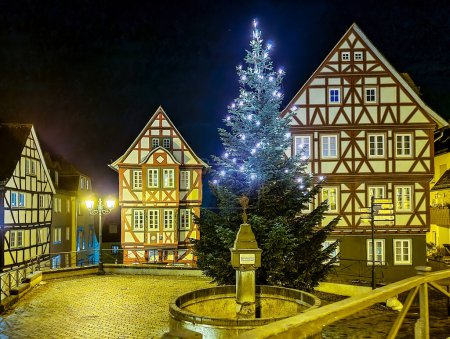 Photo for Night scene with half timbered house and Illuminated  christmas tree on a public area downtown Wetzlar. - Royalty Free Image
