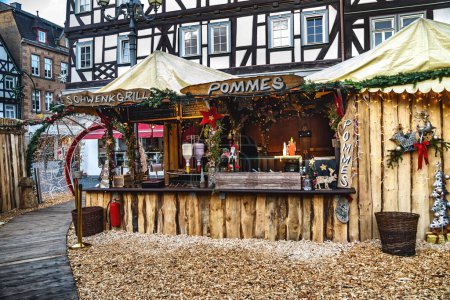 Photo for Wooden market stall decorated for Christmas, selling sausages and french fries - Royalty Free Image