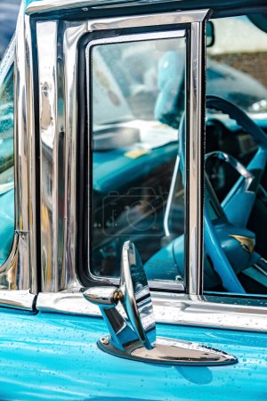 Photo for WETTENBERG, HESSE, GERMANY - 07 - 28 - 2023: Small side window and rear view mirror from Chevrolet Belair on a Car Show Golden Oldies in Krofdorf- Gleiberg, near Giessen, Hesse. - Royalty Free Image