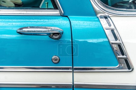 Photo for WETTENBERG, HESSE, GERMANY - 07 - 28 - 2023: Detail of a door with handle from classic Light Blue Chevrolet Belair on a Car Show Golden Oldies in Krofdorf- Gleiberg, near Giessen, Hesse. - Royalty Free Image