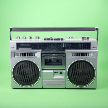 Portable Retro Tapedeck isolated on green background.