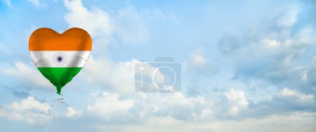 Foto de Flag of India on heart-shaped balloon against sky clouds background. Education, charity, emigration, travel and learning. Indian language concept - Imagen libre de derechos