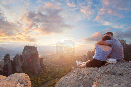 Photo for Meteora, Kalabaka Greece. Tourists couple enjoying a sunset in Meteora - Royalty Free Image