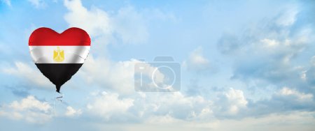 Foto de Flag of Egypt on heart-shaped balloon against sky clouds background. Education, charity, emigration, travel and learning. Egyptian language concept - Imagen libre de derechos