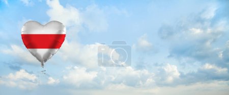 Foto de Flag of Belarus on heart-shaped balloon against sky clouds background. Education, charity, emigration, travel and learning. Belarussian language concept - Imagen libre de derechos