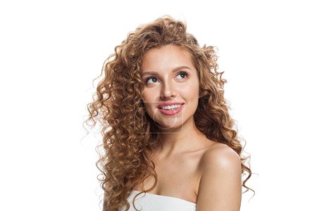 Attractive good-looking redhead woman with clean skin, curly hairstyle and natural make-up. Female model looking up on white background