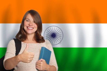 Happy woman student against Indian flag background. Travel, education and learn language in India concept