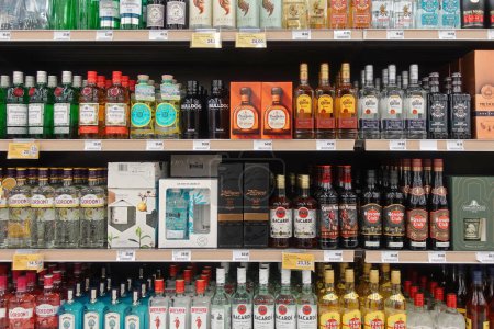 Foto de Atenas, Grecia - 6 de marzo de 2023: Tequila gin and rum alcohol beverage bottles various labels for sale at liquor store. - Imagen libre de derechos